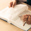 A man reading the Bible, who is part of a study group with Second Chance at Life